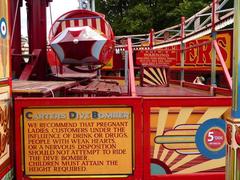 Carters Dive Bomber amusement ride with warning sign