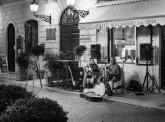 Street musicians performing in a courtyard in Stresa, Italy during an evening