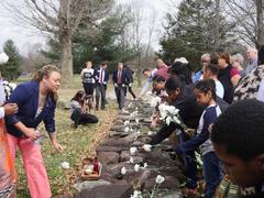 Participants laying flowers at Hermitage's enslaved memorial ceremony