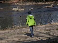 Boy on the overflow of the old dam weir in Leverkusen-Schlebusch