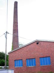 Industrial museum Freudenthaler Sensenhammer in Leverkusen-Schlebusch with a slightly tilted chimney