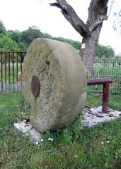 Old millstone in the courtyard of the Freudenthaler Sensenhammer Industrial Museum