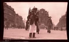 vendor selling beer on streets of Brussels with beer pack on back and mugs attached to shoulder straps