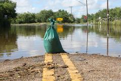 sandbag and receding flood waters in Mission, Texas