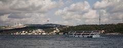 Panoramic view of the Asian shore of Istanbul with a ferry sailing on the Bosphorus, taken from the ferry docks in Beşiktaş