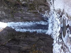 Winter view of Wolf's Waterfall in Bedollo, Trentino, Italy