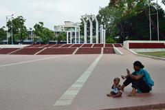 mother holding baby at Central Shaheed Minar Plaza, Dhaka