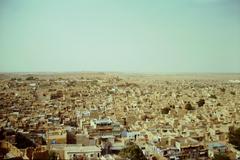 Panoramic view of Jaisalmer city with golden-hued architecture under a blue sky