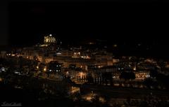 Night panoramic view of a city with illuminated buildings and streets