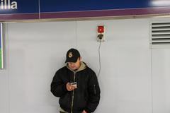 man carrying a bag at Plaza de Castilla subway station