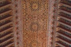 Bahia Palace interior courtyard with intricate tilework and lush garden in Marrakech, Morocco