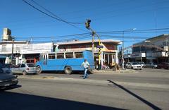 Intersection of Avenida Carlos Casares and Chavarría in Rafael Castillo, featuring a blue bus used as local transport