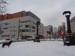 After Babel sculpture with bronze and steel columns and a canine silhouette at Promenade des Artistes in Montreal