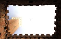 panoramic view of Siena, Italy, featuring historic buildings and the surrounding landscape