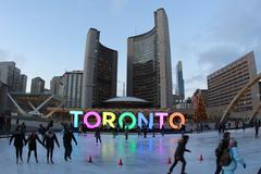 People skating near illuminated Toronto sign at Nathan Phillips Square