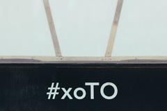 close-up of the hashtag #xoTO on the base of the 3D TORONTO sign at Nathan Phillips Square