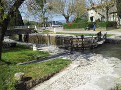 D 118 road in Carcassonne, France with canal and lock gate