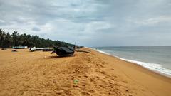 Puthenthope beach at sunset with waves and palm trees, Thiruvananthapuram District