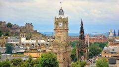 Edinburgh cityscape with castle on a hill, Ferris wheel, and Gothic tower