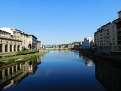 View of the Arno river with Ponte alle Grazie and houses in Florence, Italy