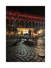 night view of Palazzo della Ragione during Christmas in Padua with city market and Vespa