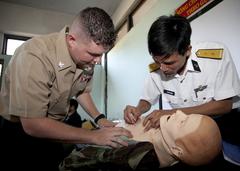 U.S. Navy Hospital Corpsman watches Vietnamese officer practice lifesaving skills