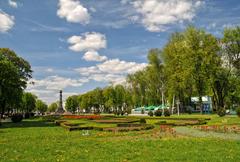 Korpusny Garden with lush green trees and a star-shaped flowerbed in Poltava, Ukraine