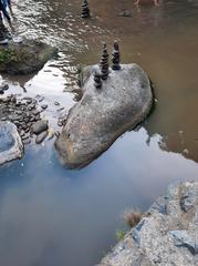 Tegenungan Waterfall with balanced stones on June 26th, 2023