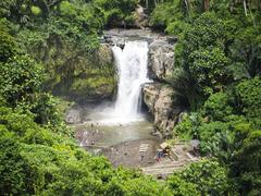 Tegenungan Waterfall in Bali surrounded by lush greenery