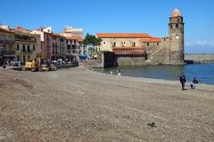 Scenic view of Collioure harbor with boats and historic buildings