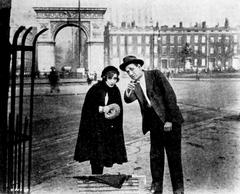 Still from the 1928 film Anybody Here Seen Kelly? with Bessie Love and an unidentified actor in Washington Square, New York City