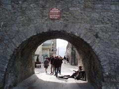 Spanish Arch in Galway, Ireland, with surrounding greenery and blue sky