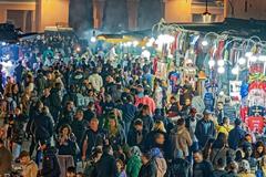 central market square of Marrakech bustling with tourists and locals