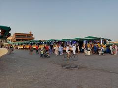 Djemaa el-Fna square in Marrakech with crowds of people, food stalls, and traditional Moroccan architecture