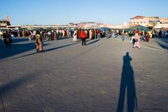 Djemaa El Fna square in Marrakesh at sunset with bustling crowds and market stalls