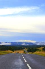 Panoramic view of Cévennes horizon with lush green hills and a cloudy sky