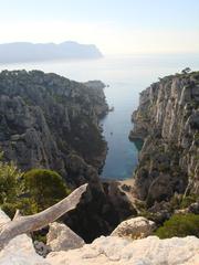 A stunning coastal cliff view in Parc national des Calanques with crystal-clear blue water and rugged limestone formations