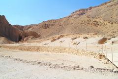 a panoramic view of the Valley of the Queens in Egypt, showing arid desert landscape and ancient tombs built into the hills