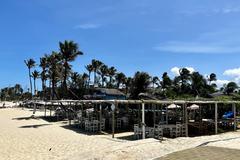 Cumbuco Beach in Brazil with clear blue water and palm trees along the shore