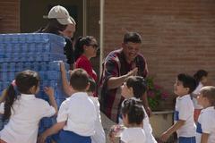 Eisenhower Carrier Strike Group sailors interacting with children in Naples, Italy during a community relations project