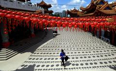 Chinese woman leaving Thean Hou Temple in Kuala Lumpur after praying