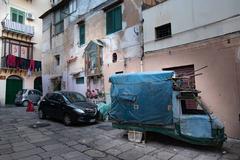 Ape mini-lorry, wayside shrine, and drying laundry in Palermo's old town