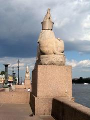 two sphinx statues on stone pedestals