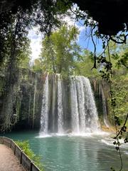 Scenic view of Düden Şelalesi waterfall surrounded by lush greenery