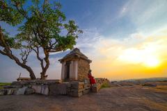 lady solo traveller on Hemakuta hill, Hampi during sunset