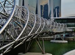 Helix Bridge in Singapore at night with city skyline in the background