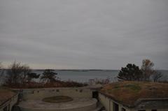 The outer islands of Boston Harbor seen from Fort Revere in Hull with Boston Harbor Light and Graves Light in the distance