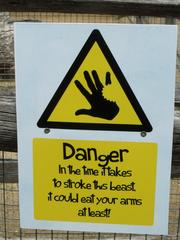 Yellow warning sign about animals at Animal Adventure in London Zoo