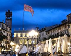 Bandiera Contarina waving in the evening in Piazza delle Erbe, Verona