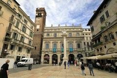 Palazzo Maffei on the Piazza delle Erbe in Verona with the Torre del Gardello and the Venetian Lion Column